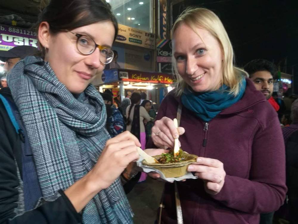 Tourists Trying Indian Street Food at a Busy Night Market