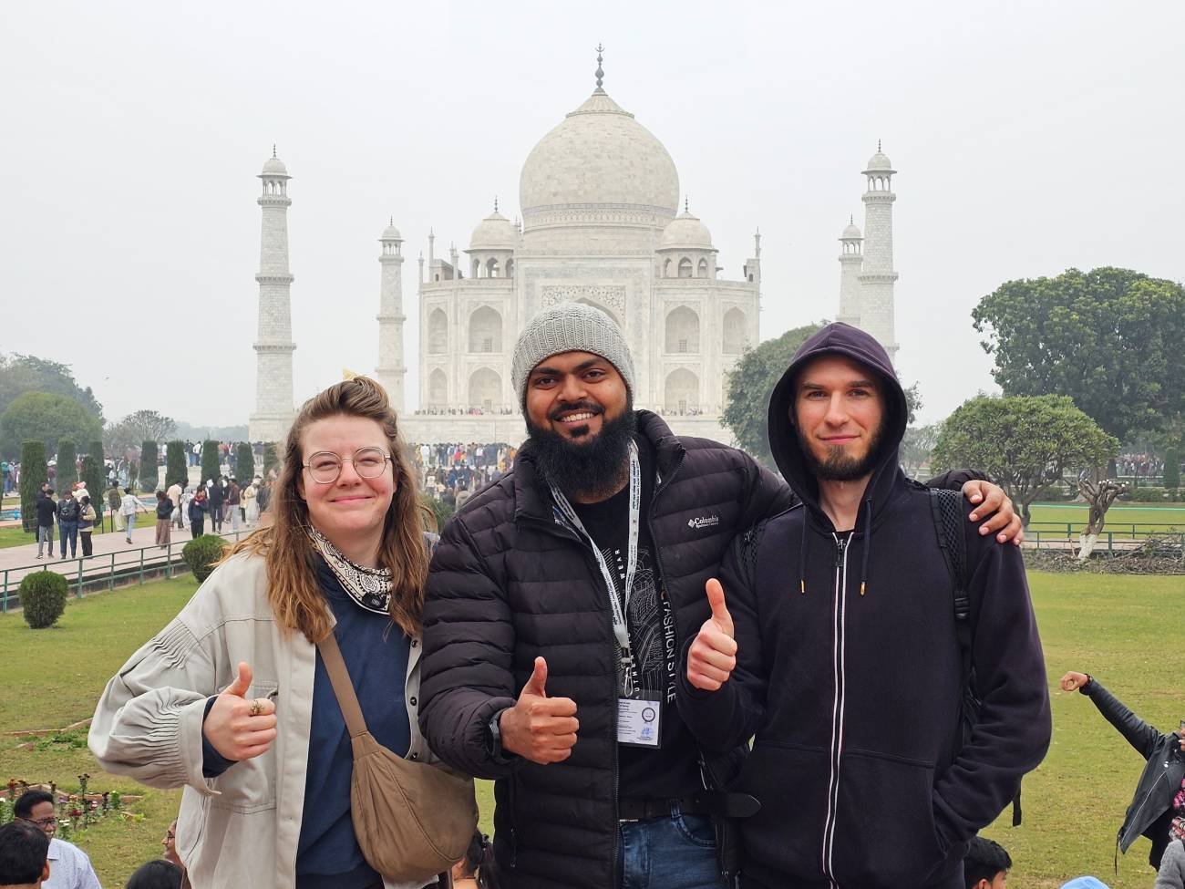 Welcome to Agra Trip Packages - A Government-Certified Travel Agency in Agra 166 Kamran Khan, a tour guide from Agra Trip Packages, standing with two international travelers in front of the Taj Mahal in Agra, India.
